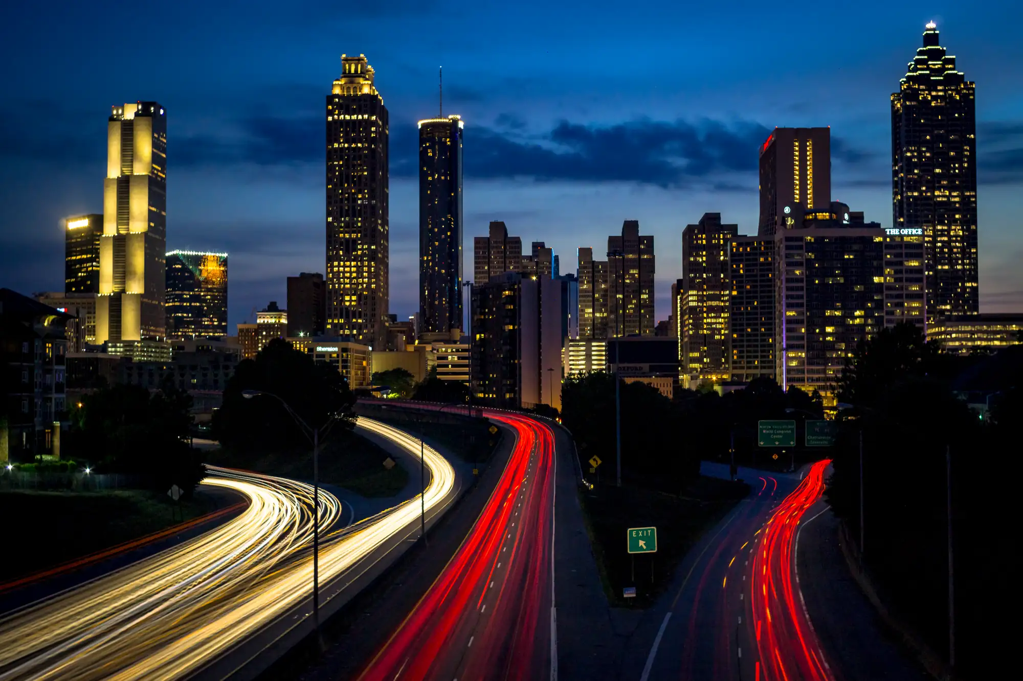 Atlanta skyline at dusk from the Jackson Street Bridge, with light trails on the Downtown Connector
