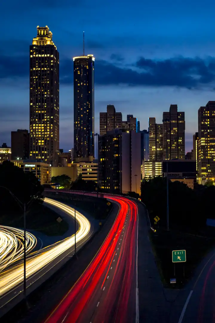 Atlanta skyline at dusk from the Jackson Street Bridge, with light trails on the Downtown Connector