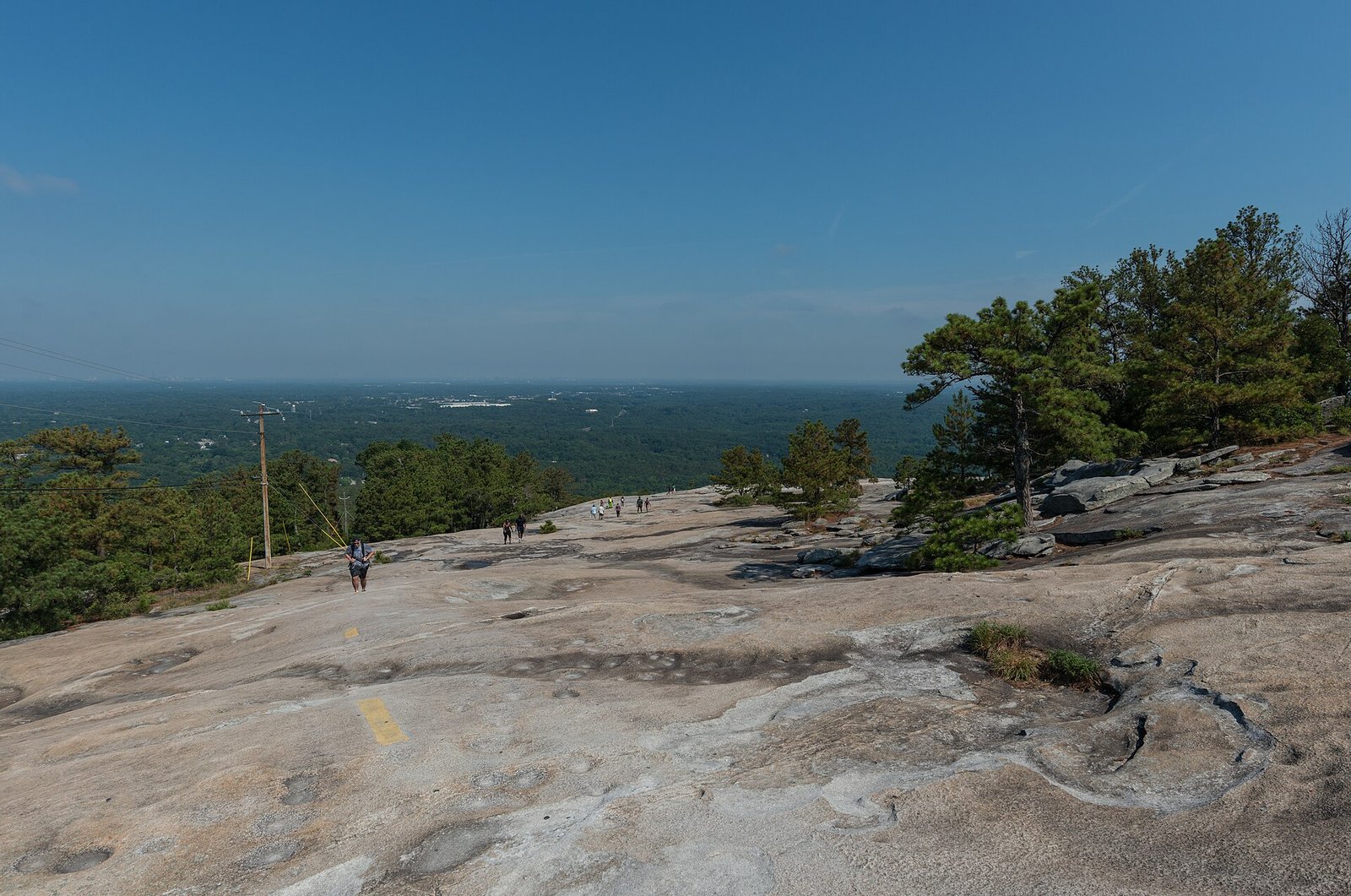 Hikers on the granite Walk-Up Trail at Stone Mountain Park