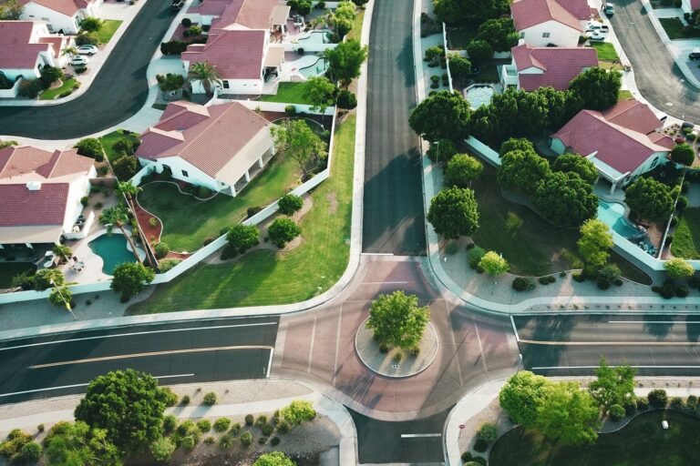 Aerial view of a suburban neighborhood of single-family homes around a small roundabout (illustrative photo, a Southwest suburb, not Georgia).