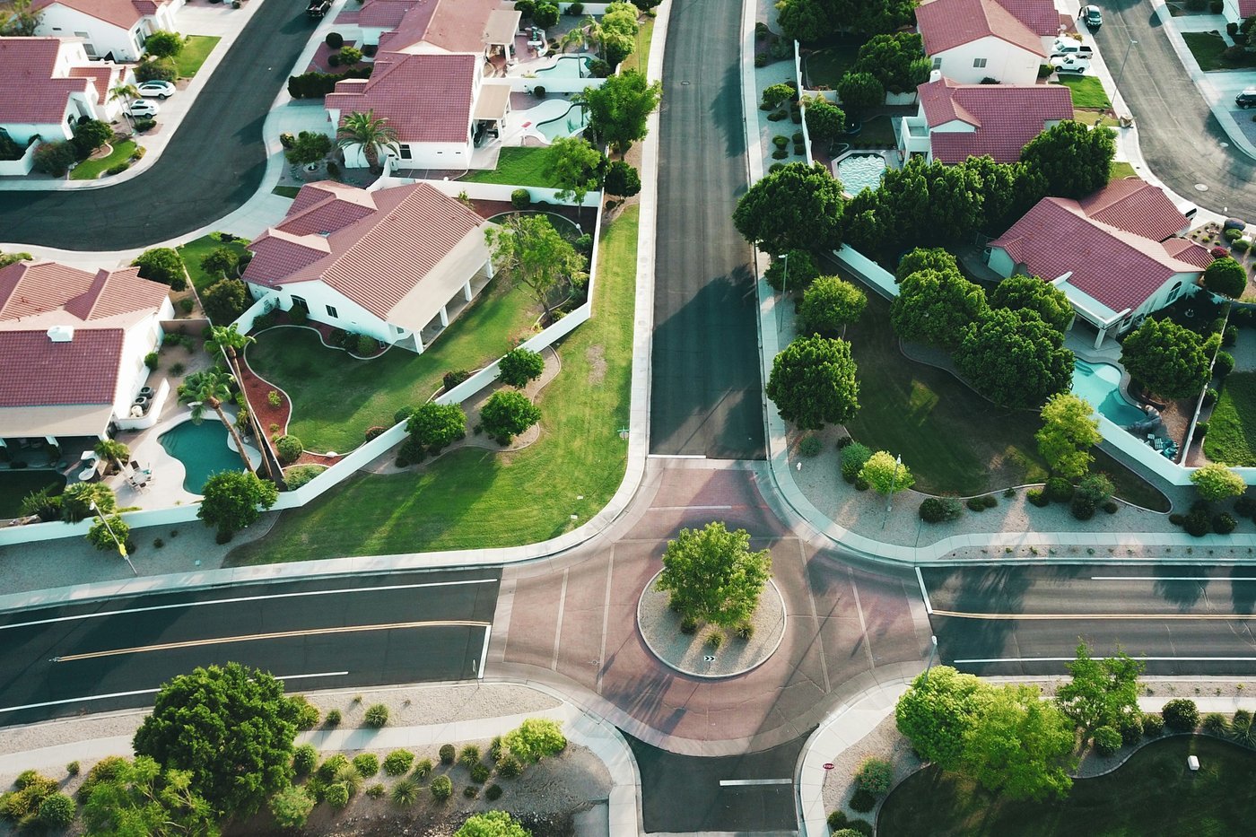 Aerial view of a suburban neighborhood of single-family homes around a small roundabout (illustrative photo, a Southwest suburb, not Georgia).