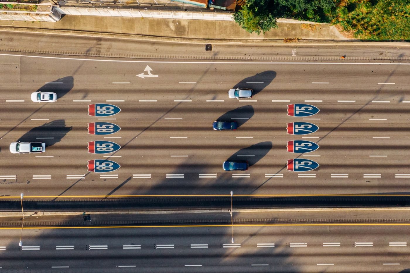 Overhead view of the I-75 and I-85 Downtown Connector in Atlanta, with interstate shields painted on the lanes