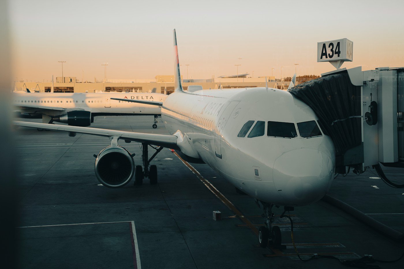 A Delta jet at gate A34 at Hartsfield-Jackson Atlanta International Airport in warm evening light