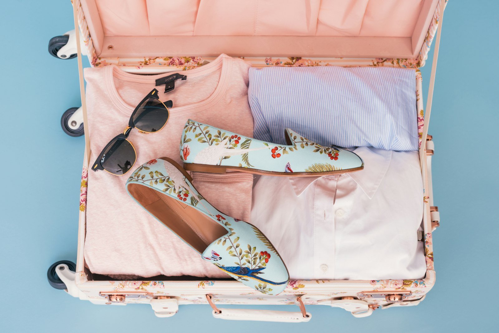 What to pack for Georgia: clothes and a pair of shoes packed in an open suitcase