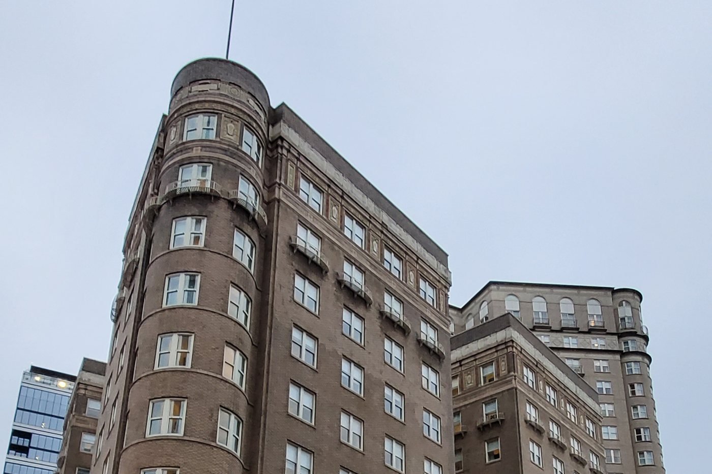 The Georgian Terrace's 1911 brick building with its rounded corner tower on Peachtree Street, with the taller 1990s tower behind it