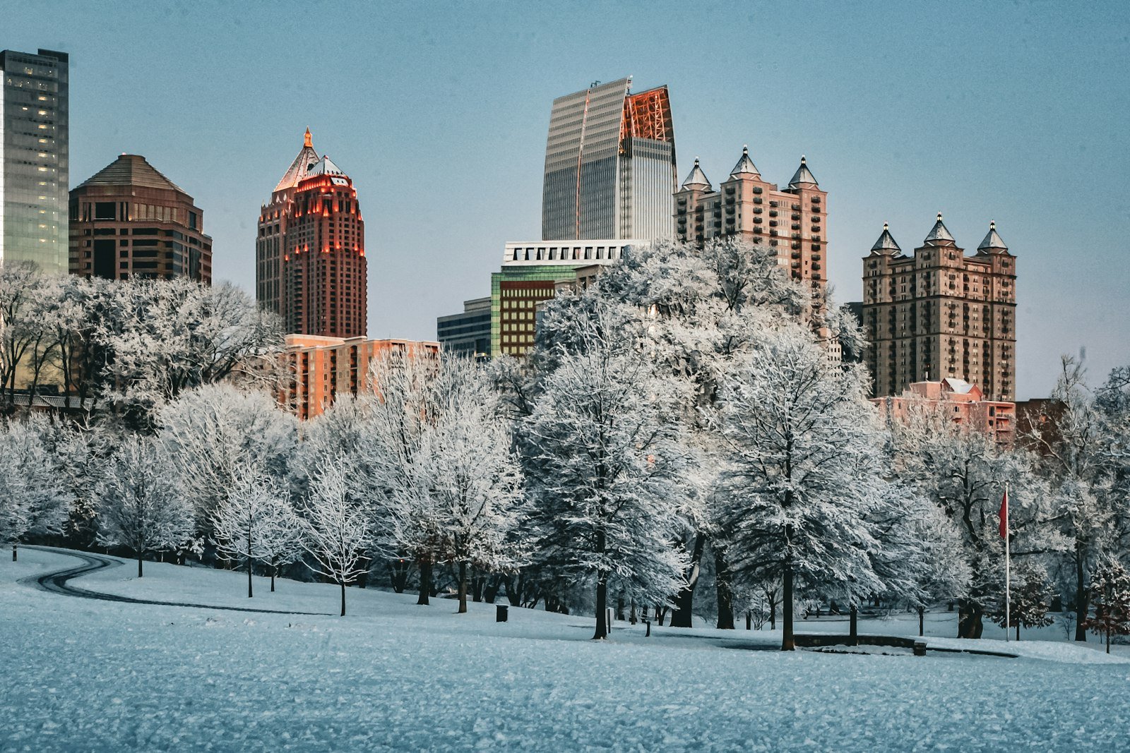 Midtown Atlanta skyline with tall buildings under snow, seen from Piedmont Park