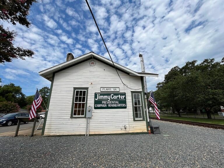The white depot building in Plains, Georgia that served as Jimmy Carter's campaign headquarters, with flags beside it