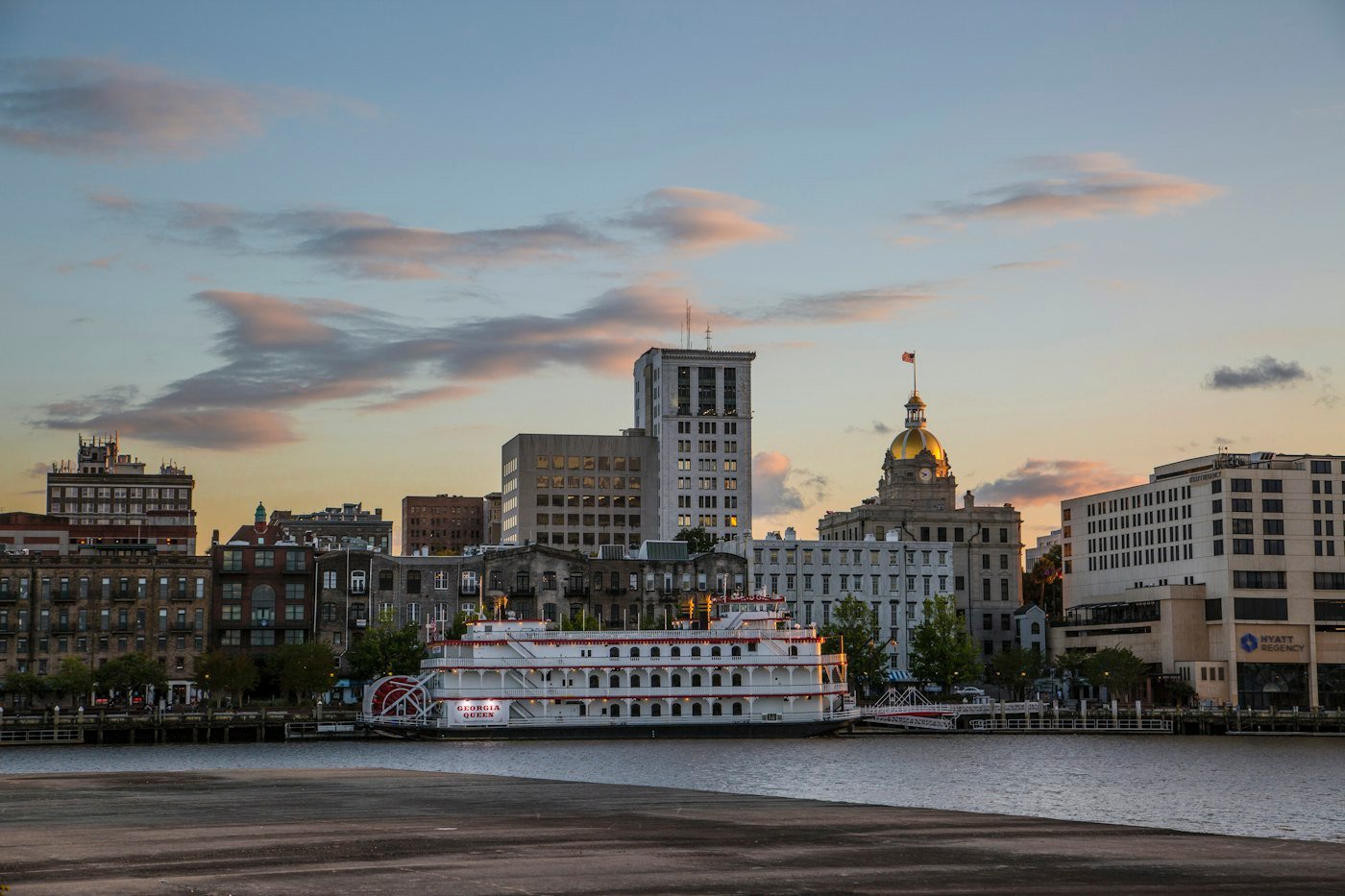 The Georgia Queen riverboat docked on the Savannah riverfront at dusk